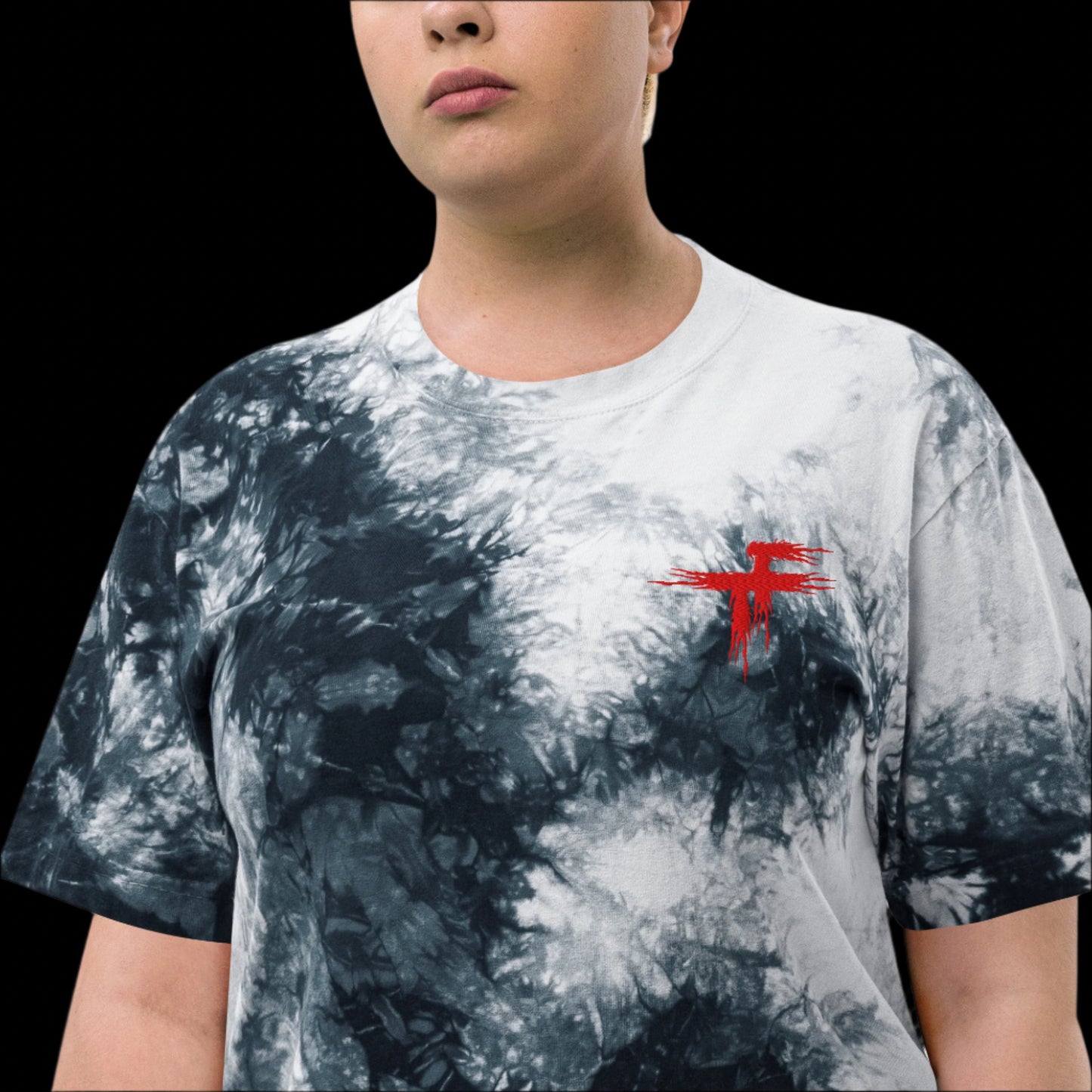 Person wearing a tie-dye t-shirt with a red logo