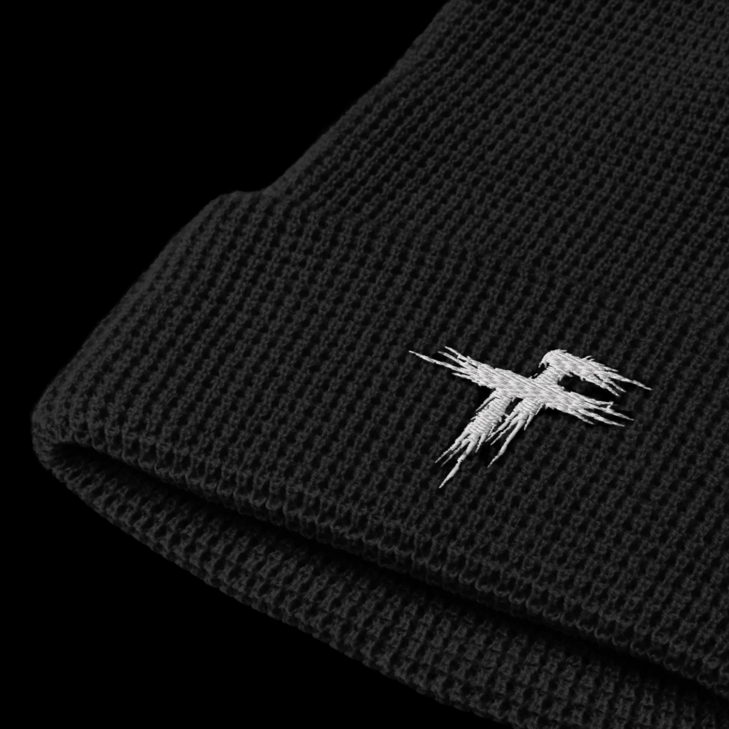 Black knit beanie with a white embroidered logo
