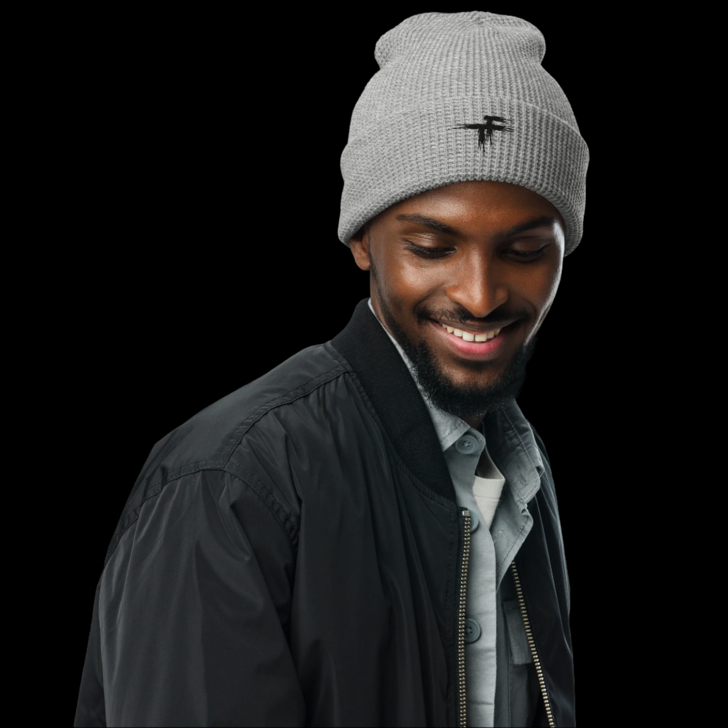 Man wearing a gray beanie with a logo and a black jacket