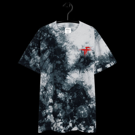 Tie-dye t-shirt with a red logo on a hanger 