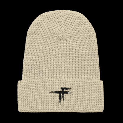 Beige knit beanie with a black logo 