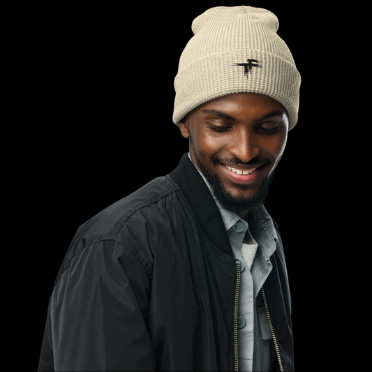 Man wearing a beige beanie with a logo 