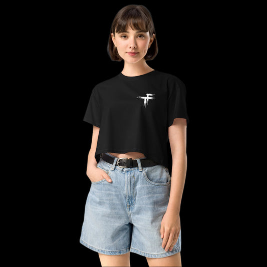 Person wearing a black t-shirt with a logo and denim short